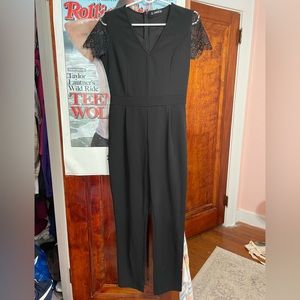 Black jumper. Zipper up the back. Lash on sleeves